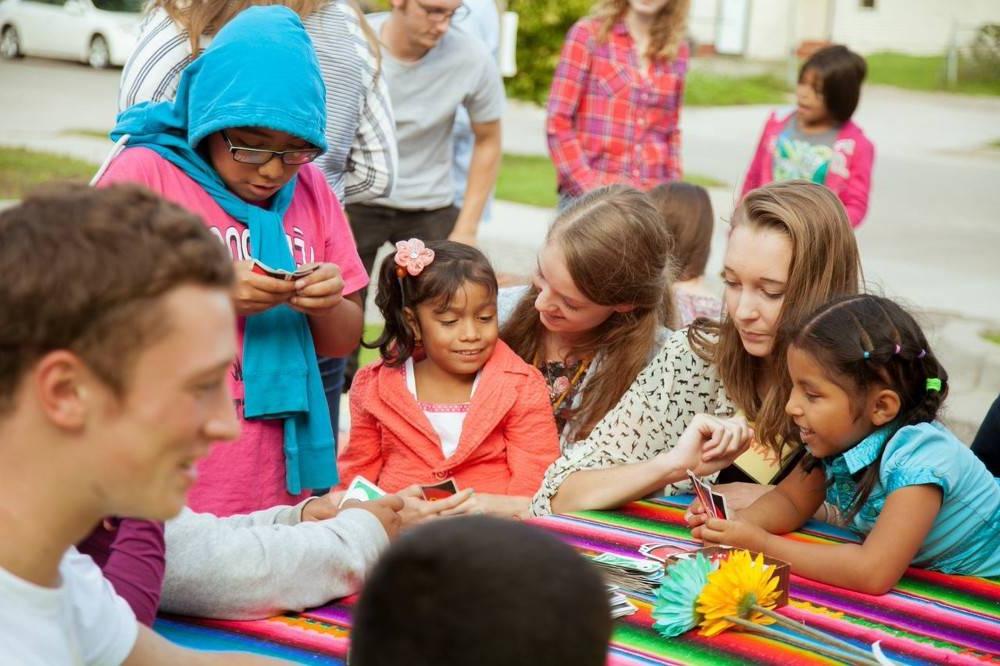 Children sitting at a table doing a craft